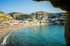 a beach with people and buildings