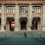 person walking pass building