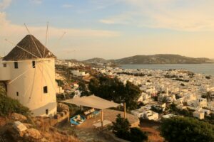 a windmill on a hill overlooking a city