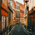 people walking on street between buildings during daytime