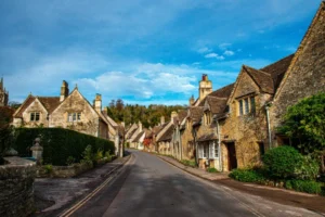 a street lined with old stone houses under a blue sky