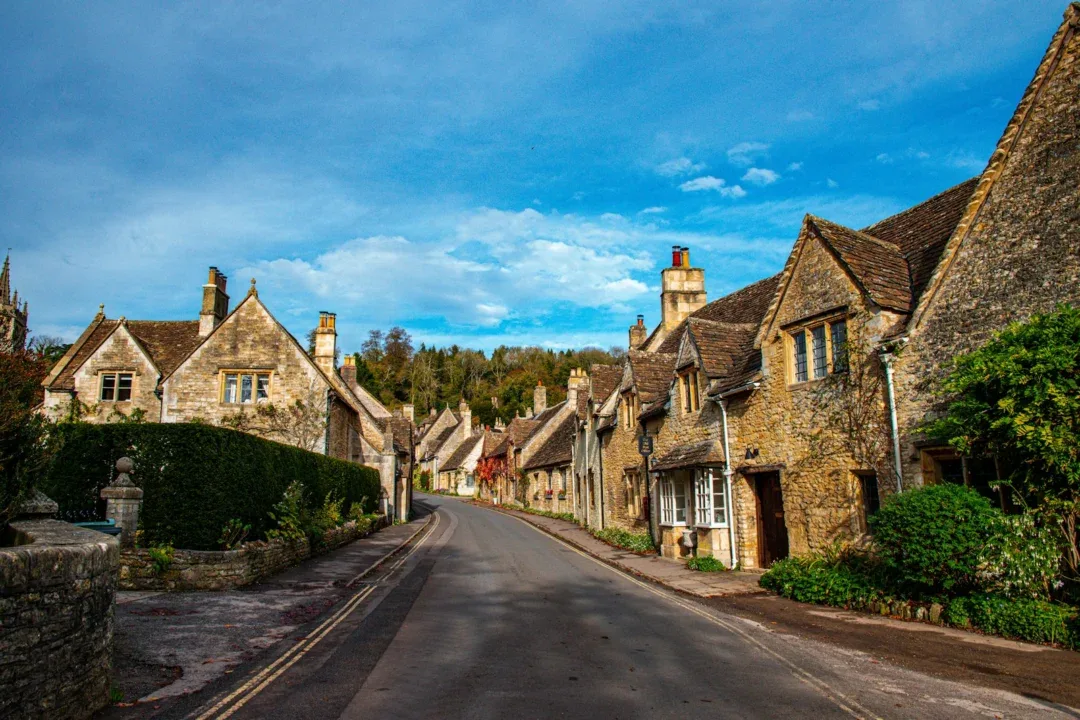 a street lined with old stone houses under a blue sky